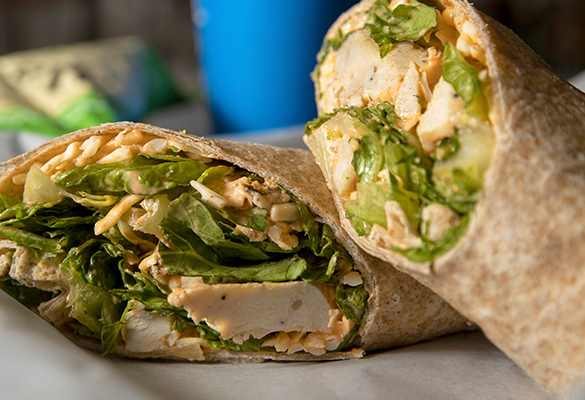 Photo of a buffalo chicken wrap with chicken, lettuce and cheese.
