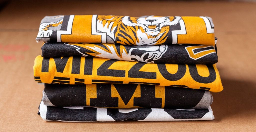 Stack of five folded vintage shirts.