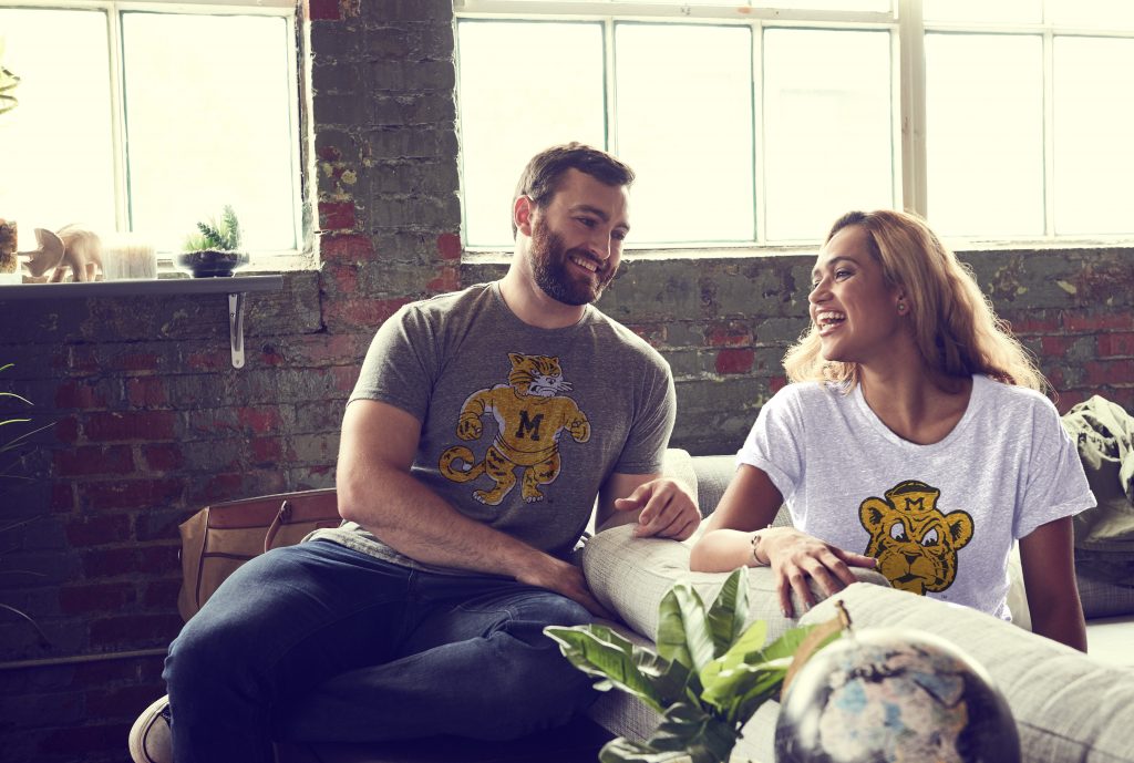 Man and Woman on couch wearing vintage mark t-shirts. 